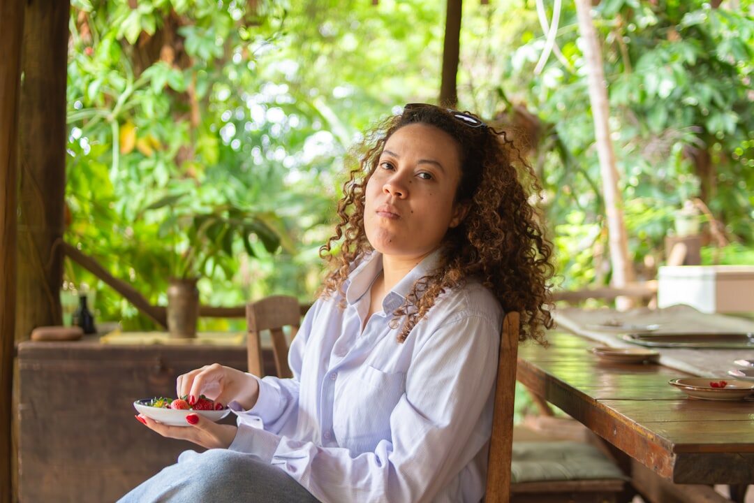 Brazilian woman writing in a journal while smiling