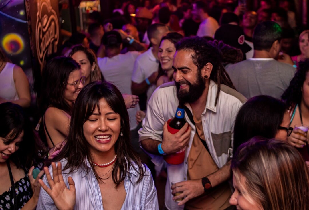 Diverse group of Brazilian people talking and laughing in a bright room